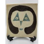 A raised plate of platter decorated with a woman's face, a mid century piece by Indian Artist