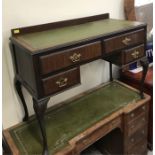 A Four drawer leather topped writing desk