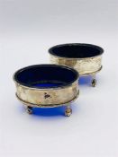 A Pair of hallmarked silver salts with blue glass liners.