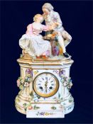 A Meissen mantle clock with some damage enamel clock face, featuring a courting couple.