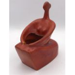 A red vase of an abstract seated nude by Indian Artist Gulbanoo McGee, when based in Bombay,