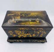 A Lacquered Chinese Tea Caddy complete with lids and inserts on bun feet