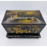 A Lacquered Chinese Tea Caddy complete with lids and inserts on bun feet