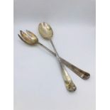 A set of white metal salad servers