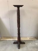 A carved wooden plant stand
