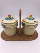 A Pair of Japanese Jam jars with a floral theme on a wooden carry stand.