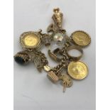 A 9ct gold charm bracelet with a number of charms to include a 1900 Sovereign, a 1910 sovereign