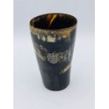 A Horn cup with glass bottom with an inscription on the cartouche dating it to 1885.