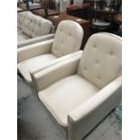 A pair of light cream reclining chairs