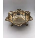 A silver bowl, hallmarked Sheffield 1930, on three legs. (410g)