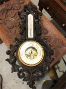 A carved wooden barometer