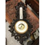 A carved wooden barometer