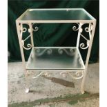 A Two tier glass a wrought iron table