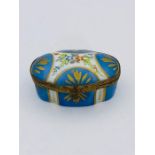 A hand painted porcelain box with gilt edging and clasp. See picture for makers mark.