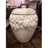 A large white bread pot with grape and vine design.