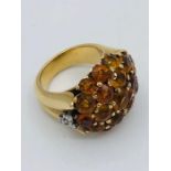 A cocktail ring with yellow semi precious stones.