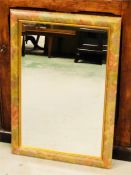 A rectangular wooden framed mirror with floral motif
