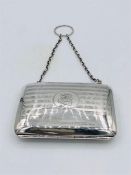 A hallmarked silver ladies purse on a chain.