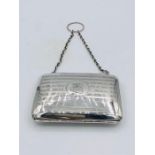 A hallmarked silver ladies purse on a chain.