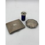 Two hallmarked silver and machine tooled Ladies compacts along with a blue glass shaker with