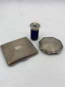 Two hallmarked silver and machine tooled Ladies compacts along with a blue glass shaker with