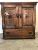 A small carved two door cabinet with drawer under. (87 x 32cm)