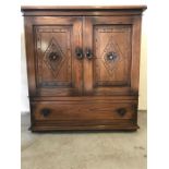 A small carved two door cabinet with drawer under. (87 x 32cm)