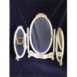 A dressing table trifold mirror with ornate detail in cream