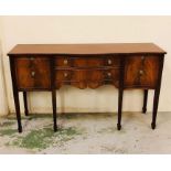 A mahogany sideboard with two central drawers and two side cupboards with brass ring handles.