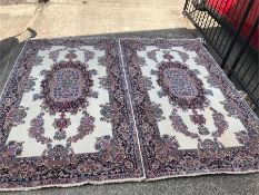 A Pair of cream ground rugs with floral borders 223cm x 128cm
