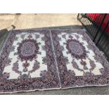 A Pair of cream ground rugs with floral borders 223cm x 128cm