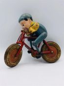 A Tri Ang Vintage toy, boy on bike