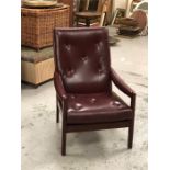 A Low armchair with Oxblood seat pad and back, made by Cintique.