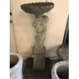 A Garden bird bath in composite concrete in the form of a Cherub