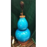 An Oriental lamp base in a turquoise blue with a floral style decoration