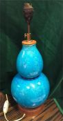 An Oriental lamp base in a turquoise blue with a floral style decoration