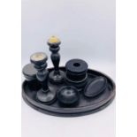 A collection of ebonised items to include candlesticks, pin dishes, tray etc.