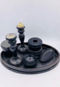 A collection of ebonised items to include candlesticks, pin dishes, tray etc.