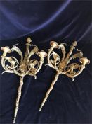 A Pair of gilt wall lights with goat heads and grape entwined casting.