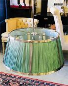 A Large Chrome ceiling light with six candle style lights and a pale green pleated shade (80cm