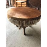 A cow hide table or footstool