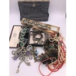 A selection of costume jewellery and a Vintage evening bag.