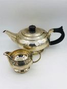 A silver teapot and milk jug. (545g)