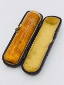 An Amber cigar holder with a 9ct gold mount