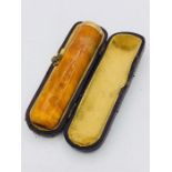An Amber cigar holder with a 9ct gold mount