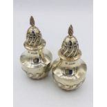 A pair of hallmarked silver pepper pots, makers mark JDWD Sheffield 1892.