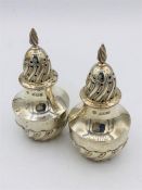 A pair of hallmarked silver pepper pots, makers mark JDWD Sheffield 1892.