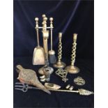 A selection of assorted brass items to include a fireside companion set, candlesticks and bellows.