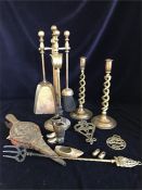 A selection of assorted brass items to include a fireside companion set, candlesticks and bellows.