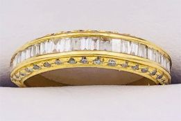 A Diamond half eternity ring. Front channel set section containing a total of twenty seven